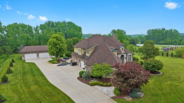 24355 S Arranmore Way, Frankfort, IL 60423 - view of front facade with a chimney, a front lawn, driveway, brick siding, and an attached garage