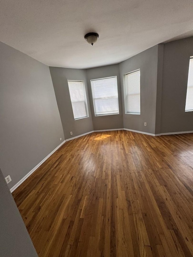 3926 W Flournoy St, Chicago, IL 60624 - spare room with dark wood-style floors and baseboards