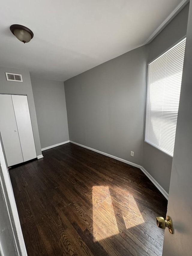 3926 W Flournoy St, Chicago, IL 60624 - unfurnished bedroom featuring dark wood-style flooring and baseboards