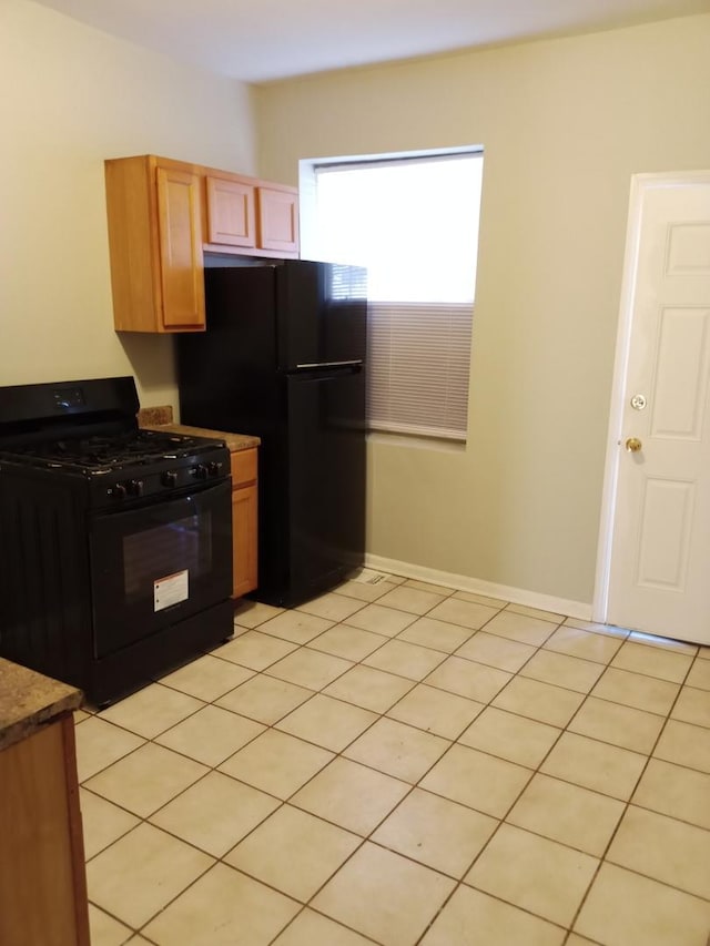 3926 W Flournoy St, Chicago, IL 60624 - kitchen featuring black appliances, baseboards, and light tile patterned floors