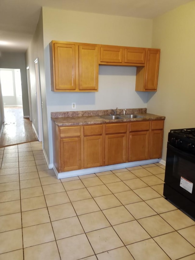 3926 W Flournoy St, Chicago, IL 60624 - kitchen with a sink, black range with gas cooktop, and light tile patterned flooring