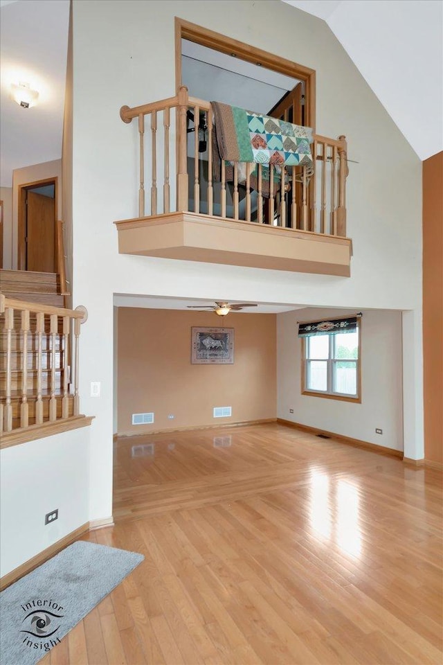 2985 Royal Ct, New Lenox, IL 60451 - unfurnished living room featuring high vaulted ceiling, baseboards, wood finished floors, and ceiling fan