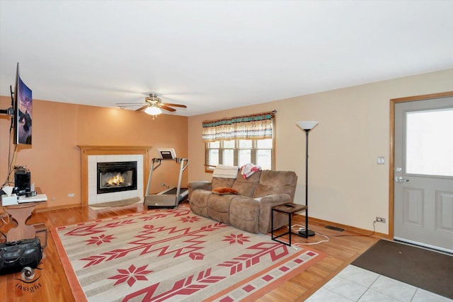 2985 Royal Ct, New Lenox, IL 60451 - living room featuring a fireplace, a ceiling fan, wood finished floors, and baseboards