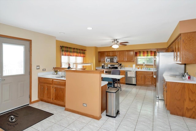 2985 Royal Ct, New Lenox, IL 60451 - kitchen featuring appliances with stainless steel finishes, plenty of natural light, brown cabinetry, and light countertops