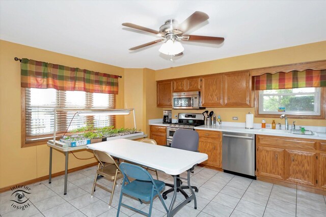 2985 Royal Ct, New Lenox, IL 60451 - kitchen featuring appliances with stainless steel finishes, a sink, brown cabinets, and light countertops