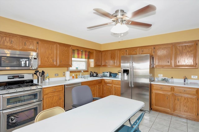 2985 Royal Ct, New Lenox, IL 60451 - kitchen with stainless steel appliances, light countertops, light tile patterned floors, brown cabinets, and a sink