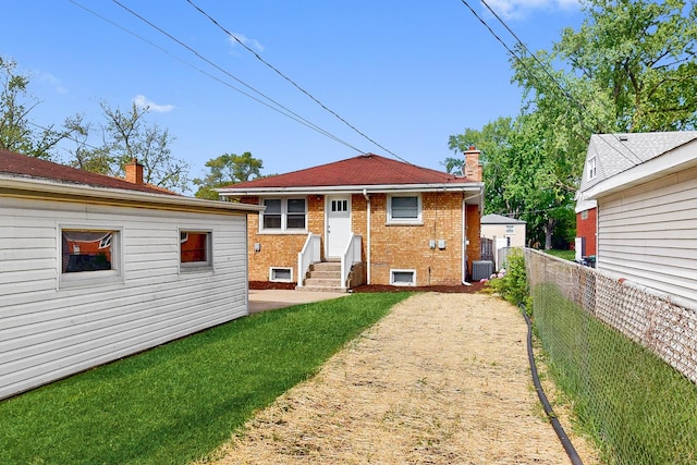 521 Buckthorn Ln, Hillside, IL 60162 - rear view of property with entry steps, brick siding, a chimney, and cooling unit