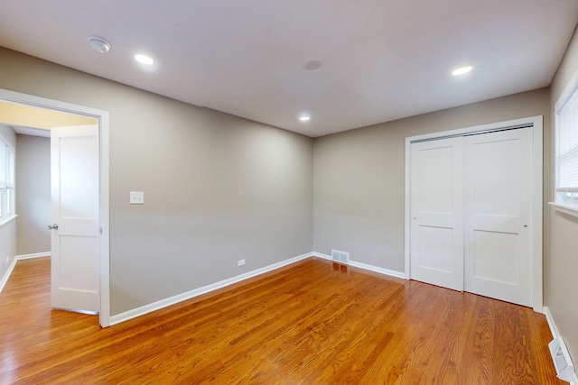 521 Buckthorn Ln, Hillside, IL 60162 - unfurnished bedroom with light wood finished floors, a closet, baseboards, and recessed lighting
