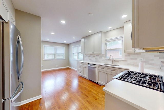 521 Buckthorn Ln, Hillside, IL 60162 - kitchen with appliances with stainless steel finishes, a sink, decorative backsplash, plenty of natural light, and recessed lighting