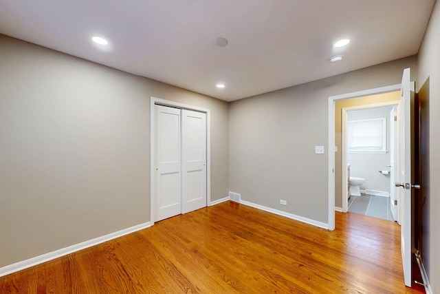 521 Buckthorn Ln, Hillside, IL 60162 - unfurnished bedroom featuring a closet, baseboards, light wood finished floors, and recessed lighting