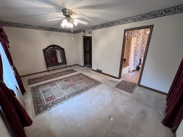 308 Tree Ln, Prophetstown, IL 61277 - unfurnished bedroom featuring baseboards, light carpet, ensuite bath, and a ceiling fan