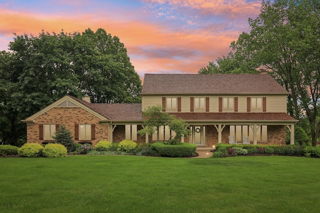 7316 Gleneagle Cir, Lakewood, IL 60014 - view of front of house with brick siding, a front lawn, a chimney, and a porch