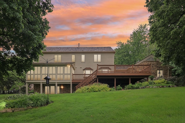 7316 Gleneagle Cir, Lakewood, IL 60014 - back of house at dusk with a yard, a wooden deck, and stairway