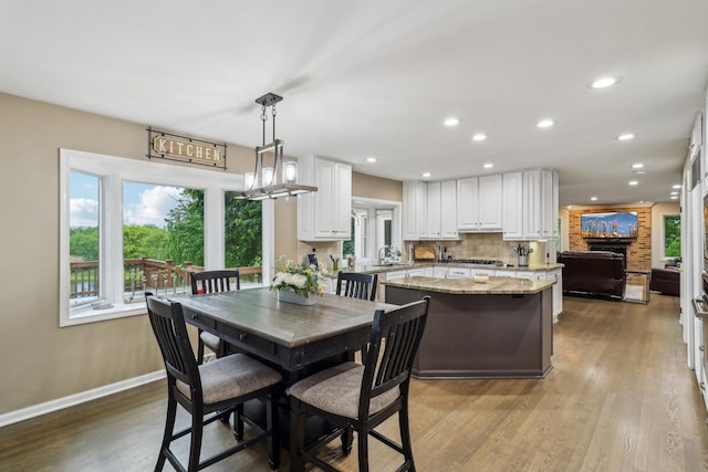 7316 Gleneagle Cir, Lakewood, IL 60014 - dining space featuring recessed lighting, wood finished floors, baseboards, and a fireplace