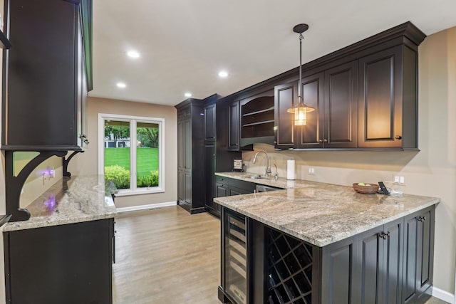 7316 Gleneagle Cir, Lakewood, IL 60014 - kitchen with light stone countertops, a sink, light wood finished floors, wine cooler, and a peninsula