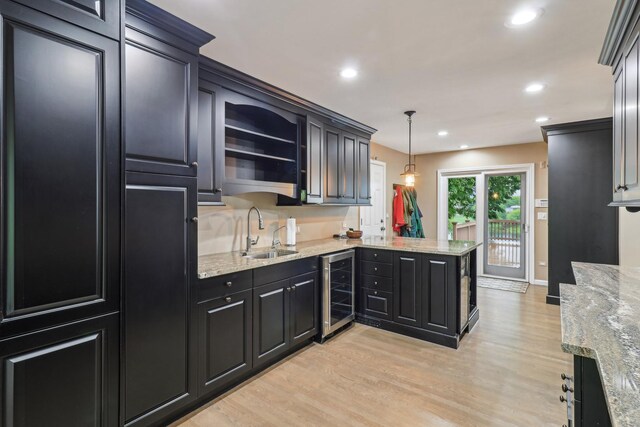 7316 Gleneagle Cir, Lakewood, IL 60014 - kitchen with wine cooler, a sink, a peninsula, light wood-type flooring, and recessed lighting