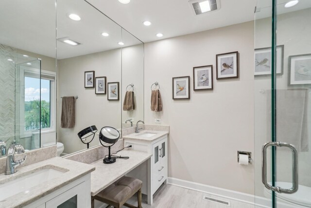 7316 Gleneagle Cir, Lakewood, IL 60014 - bathroom with vanity, toilet, a stall shower, wood finished floors, and recessed lighting