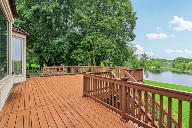 7316 Gleneagle Cir, Lakewood, IL 60014 - deck featuring a water view, view of scattered trees, and a lawn