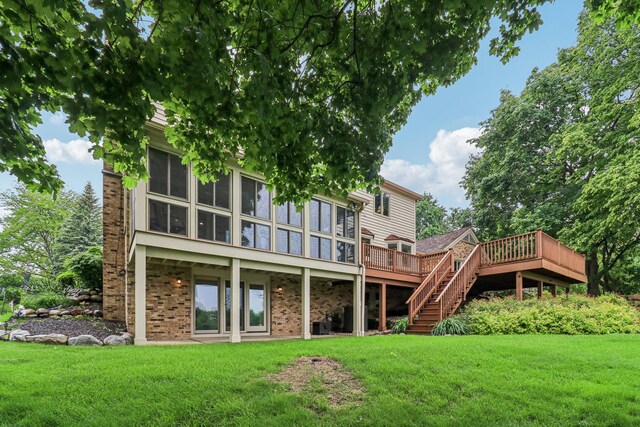 7316 Gleneagle Cir, Lakewood, IL 60014 - back of property with a deck, a yard, a sunroom, and stairway