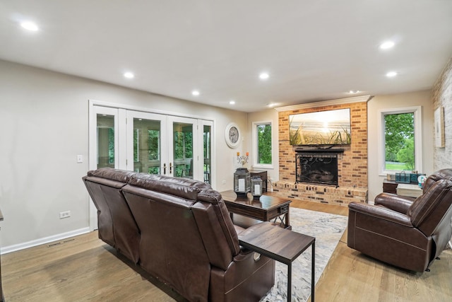 7316 Gleneagle Cir, Lakewood, IL 60014 - living room with a fireplace, light wood finished floors, recessed lighting, french doors, and healthy amount of natural light