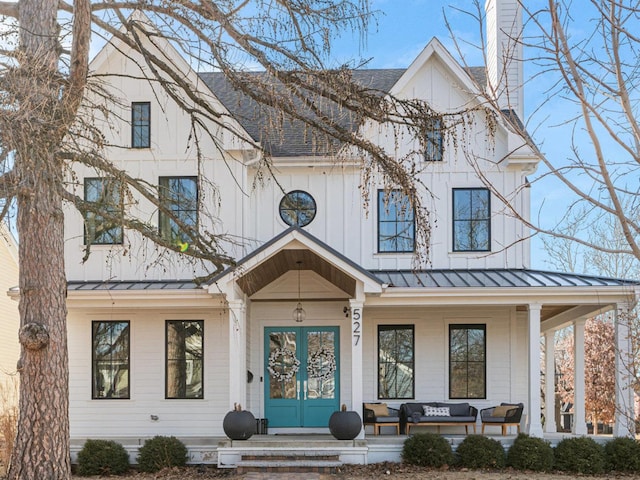 527 N Ellsworth St, Naperville, IL 60563 - modern farmhouse style home with a standing seam roof, roof with shingles, outdoor lounge area, and a chimney