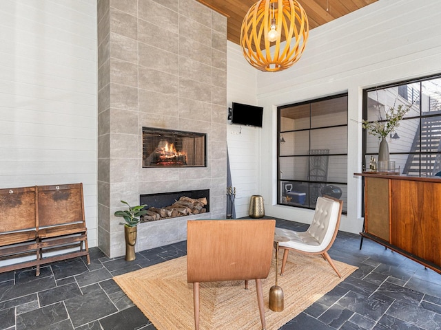 527 N Ellsworth St, Naperville, IL 60563 - interior space featuring a fireplace, wooden ceiling, stone tile flooring, a towering ceiling, and a chandelier