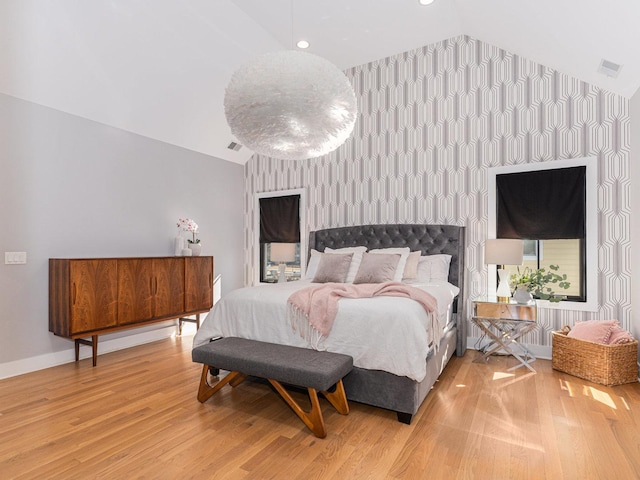 527 N Ellsworth St, Naperville, IL 60563 - bedroom featuring lofted ceiling, light wood-type flooring, an accent wall, wallpapered walls, and baseboards