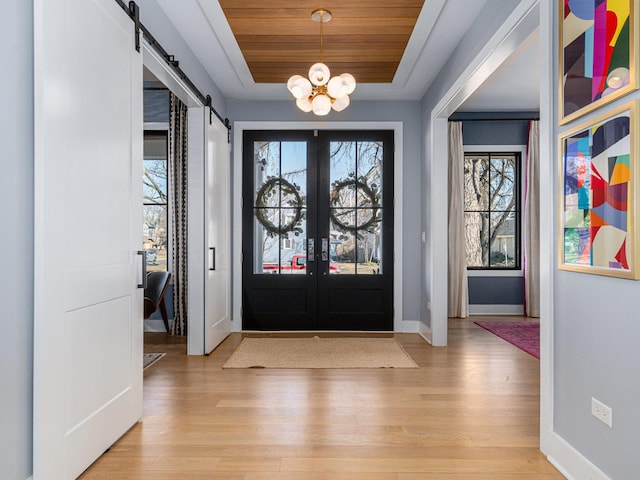 527 N Ellsworth St, Naperville, IL 60563 - foyer entrance with a raised ceiling, light wood finished floors, a barn door, wooden ceiling, and a chandelier