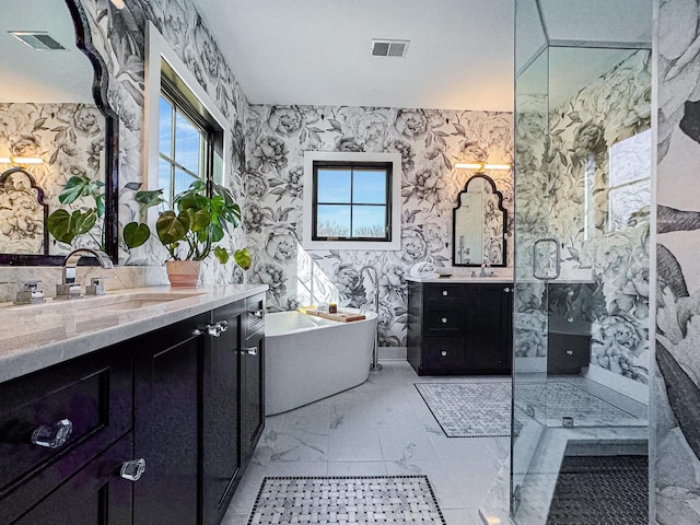 527 N Ellsworth St, Naperville, IL 60563 - bathroom featuring wallpapered walls, a freestanding tub, two vanities, a walk in shower, and marble finish flooring