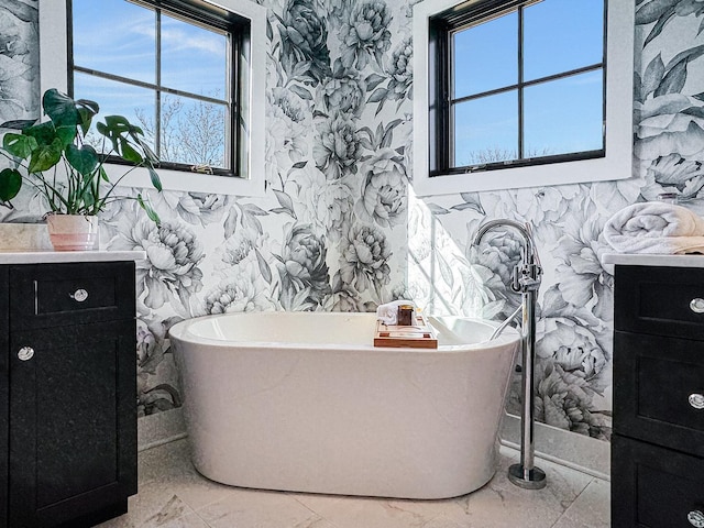 527 N Ellsworth St, Naperville, IL 60563 - bathroom featuring wallpapered walls, a soaking tub, healthy amount of natural light, and vanity