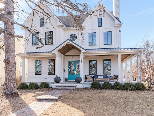 527 N Ellsworth St, Naperville, IL 60563 - modern farmhouse featuring covered porch, a standing seam roof, a chimney, metal roof, and board and batten siding