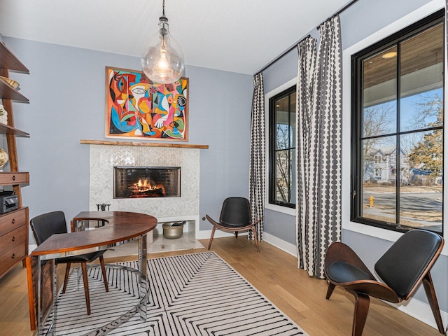 527 N Ellsworth St, Naperville, IL 60563 - office area featuring light wood finished floors, a tiled fireplace, and baseboards