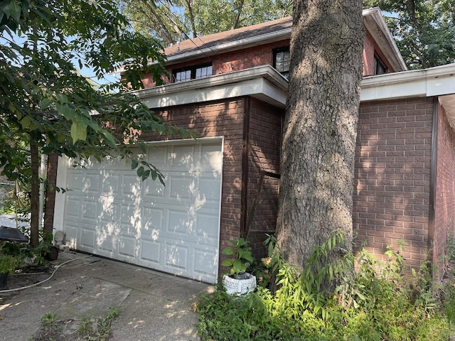 12116 S Stewart Ave, Chicago, IL 60628 - view of side of property featuring brick siding and a garage