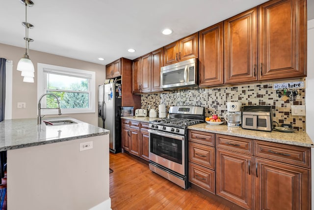127 Saint Joseph Ave, Joliet, IL 60436 - kitchen featuring stainless steel appliances, a sink, light wood-style floors, decorative backsplash, and recessed lighting