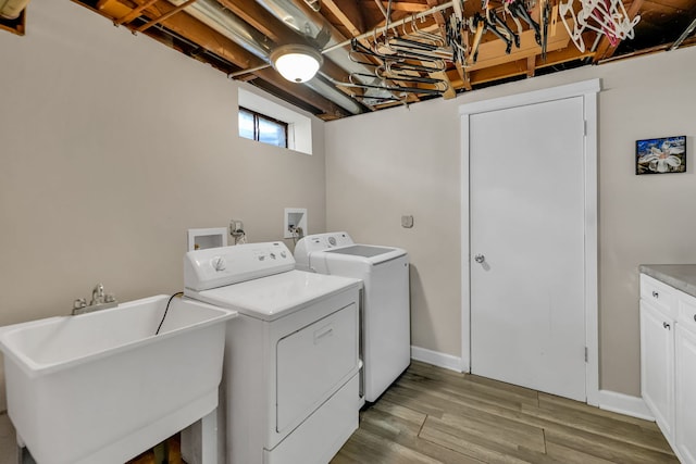 127 Saint Joseph Ave, Joliet, IL 60436 - washroom featuring washing machine and dryer, a sink, and light wood-type flooring