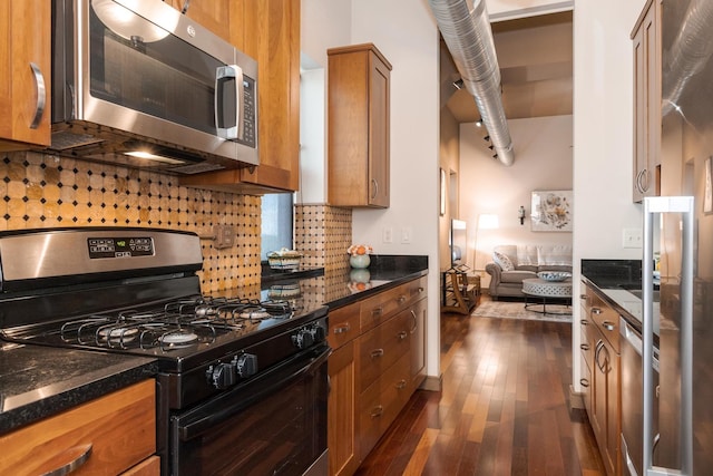 212 N Center St Unit 502, Bloomington, IL 61701 - kitchen with stainless steel appliances, brown cabinets, dark wood finished floors, and tasteful backsplash
