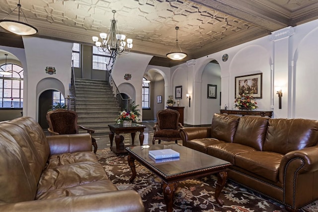 212 N Center St Unit 502, Bloomington, IL 61701 - living room featuring ornamental molding, arched walkways, a chandelier, stairway, and an ornate ceiling
