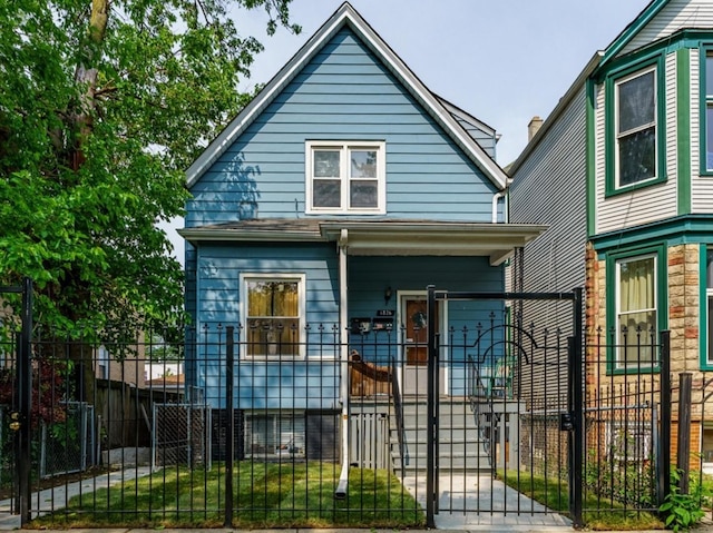1826 N Keeler Ave, Chicago, IL 60639 - view of front facade with a porch, a gate, and a fenced front yard