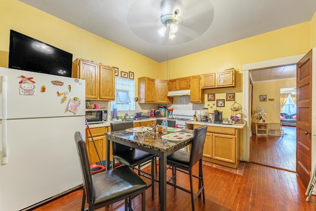 1826 N Keeler Ave, Chicago, IL 60639 - kitchen with white appliances, under cabinet range hood, ceiling fan, and healthy amount of natural light