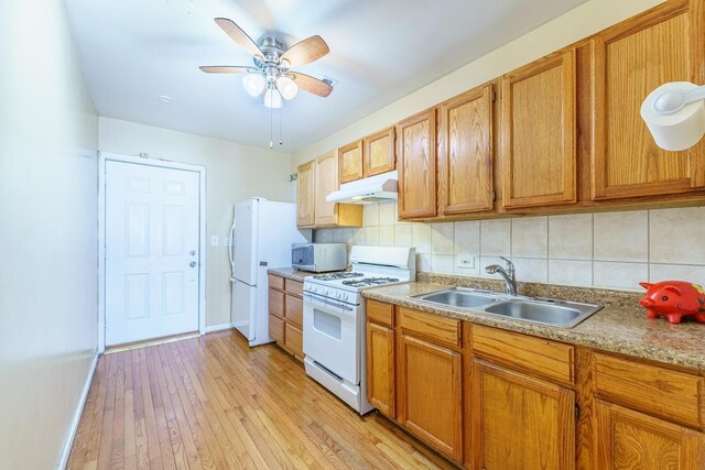 1826 N Keeler Ave, Chicago, IL 60639 - kitchen with white appliances, under cabinet range hood, a sink, and decorative backsplash