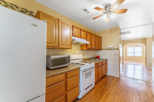 1826 N Keeler Ave, Chicago, IL 60639 - kitchen featuring white appliances, a sink, under cabinet range hood, a ceiling fan, and arched walkways