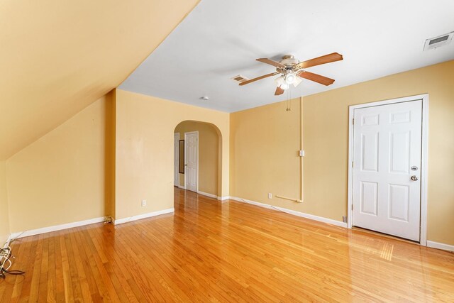 1826 N Keeler Ave, Chicago, IL 60639 - unfurnished living room featuring ceiling fan, arched walkways, light wood finished floors, and baseboards