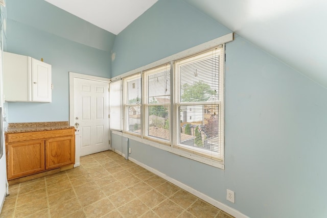 1826 N Keeler Ave, Chicago, IL 60639 - unfurnished dining area with lofted ceiling and baseboards