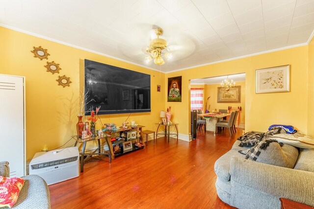 1826 N Keeler Ave, Chicago, IL 60639 - living area featuring ornamental molding, wood finished floors, ceiling fan, and a chandelier