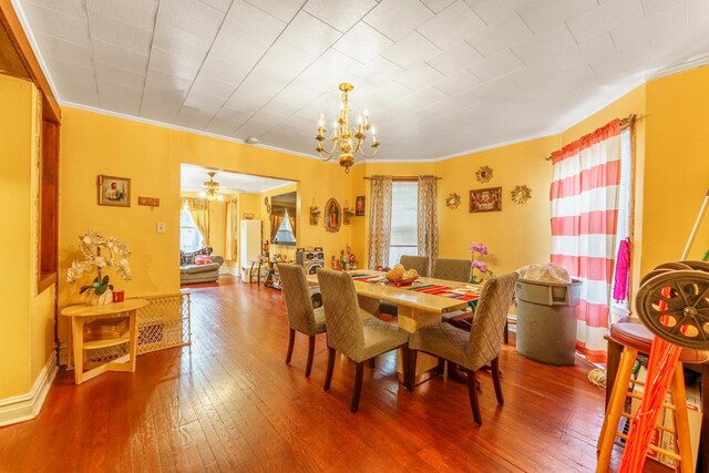 1826 N Keeler Ave, Chicago, IL 60639 - dining area with a chandelier, hardwood / wood-style flooring, ornamental molding, and baseboards