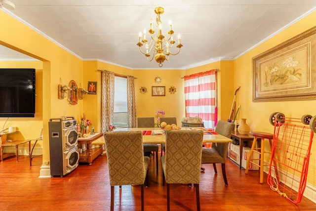 1826 N Keeler Ave, Chicago, IL 60639 - dining space with a chandelier, crown molding, and dark wood-type flooring