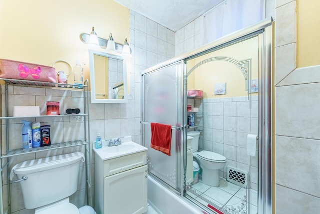 1826 N Keeler Ave, Chicago, IL 60639 - bathroom featuring tile walls, toilet, vanity, and enclosed tub / shower combo