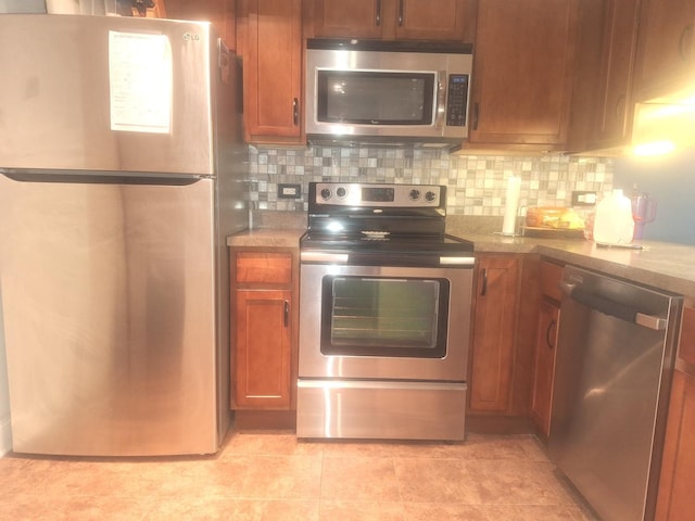 840 Elder Rd Unit A305, Homewood, IL 60430 - kitchen featuring appliances with stainless steel finishes, tasteful backsplash, and brown cabinets