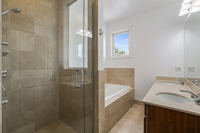 828 N California Ave Unit 3, Chicago, IL 60622 - bathroom featuring a bath, a stall shower, double vanity, and tile patterned floors
