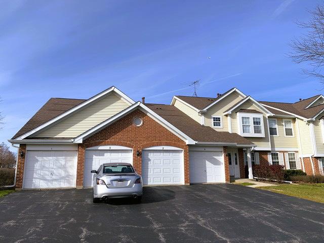 308 Ashbury Ct Unit 1515-1, Roselle, IL 60172 - view of front facade featuring driveway, brick siding, and an attached garage